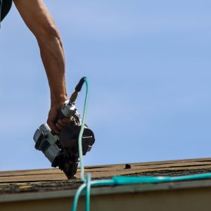 Roofers working on replacing the house installed new shingles